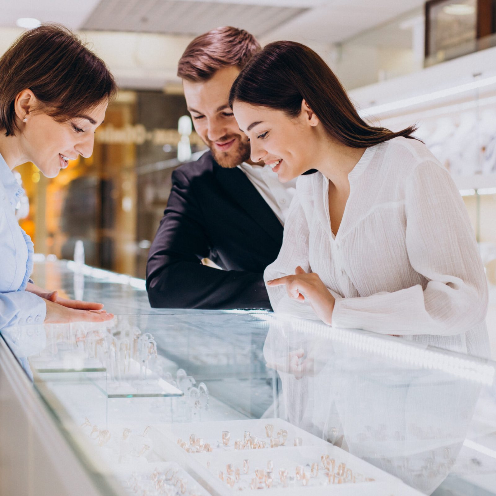 Couple at jewelry shop choosing a necklace together